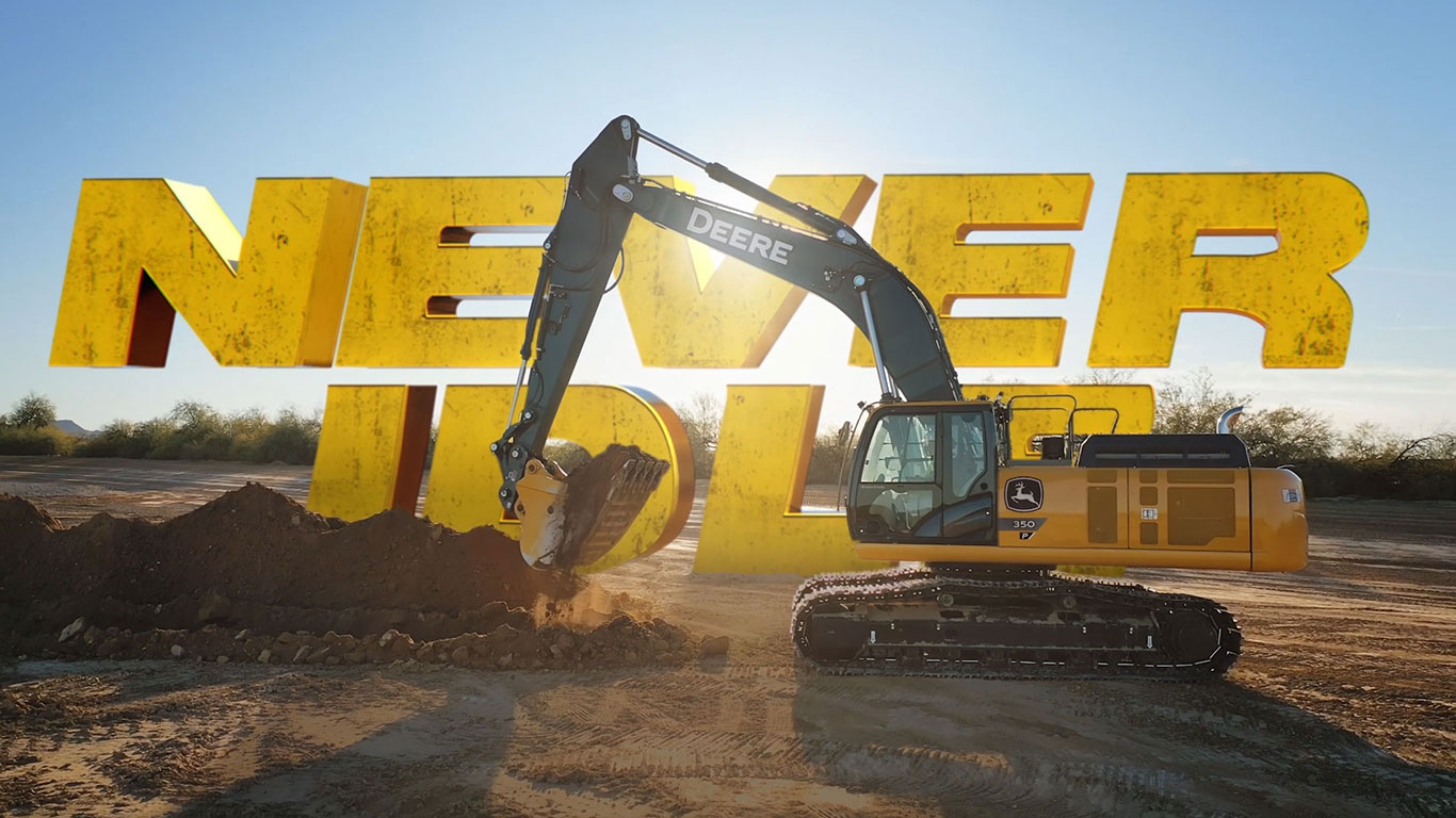 NEVER IDLE text behind an excavator