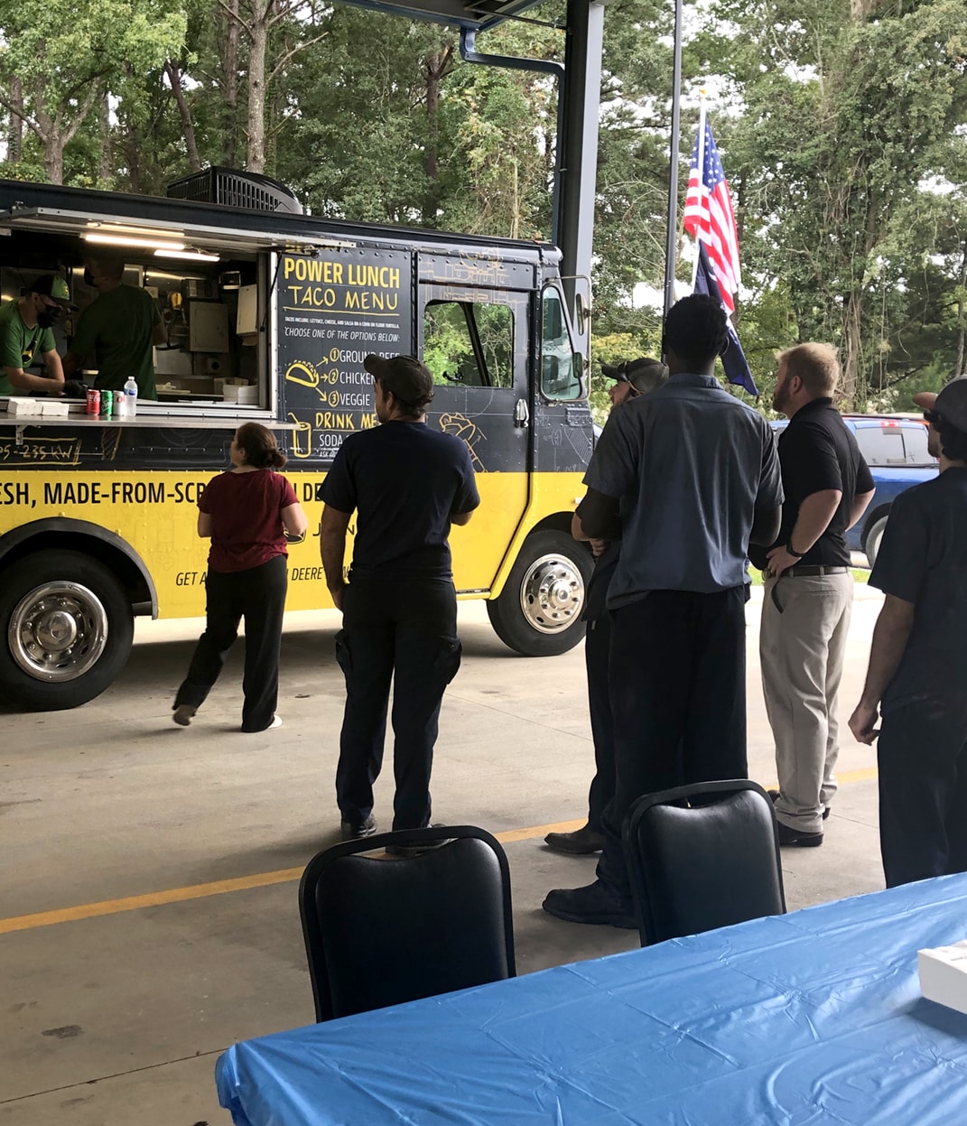 workers lining up for the taco truck outside of W. W. Williams