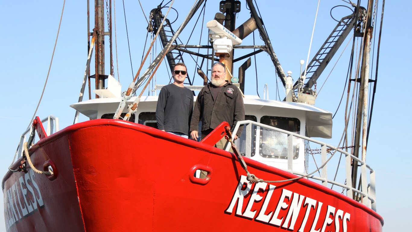 Owen and Jake Smith standing on the hull of commercial fishing boat “Relentless”