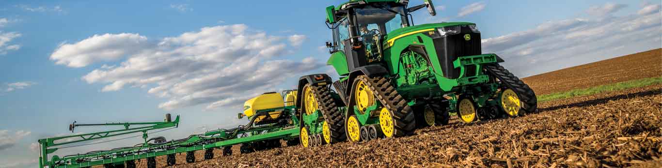 Tractor with sprayer attachement sitting in a field