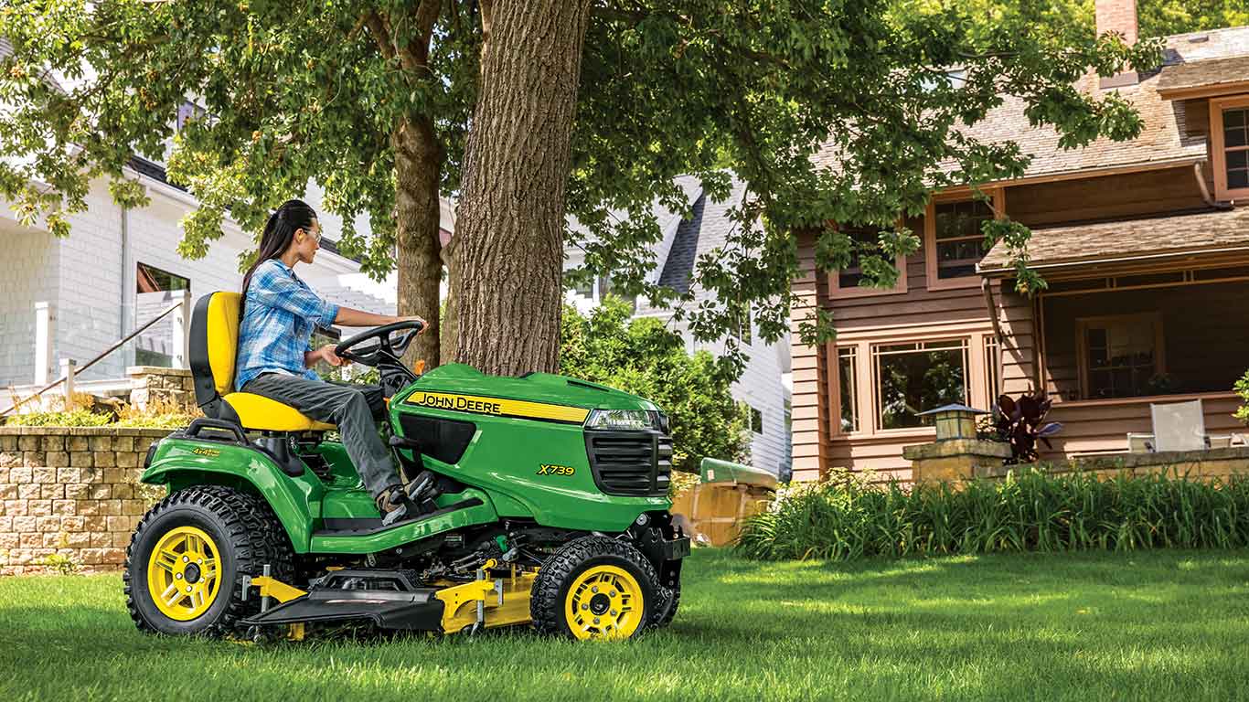 Woman operating a John Deere X739 Signature Series Lawn Tractor