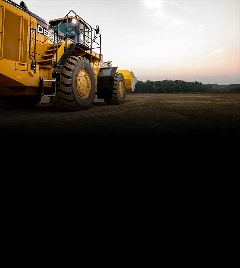 Vue latérale d'une chargeuse 944K de John Deere dans un champ de terre