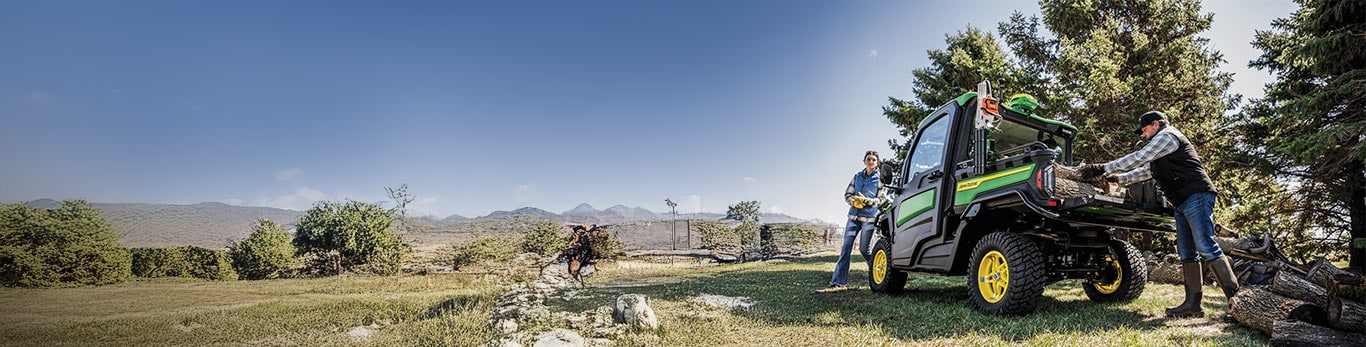 Man loading logs onto gator