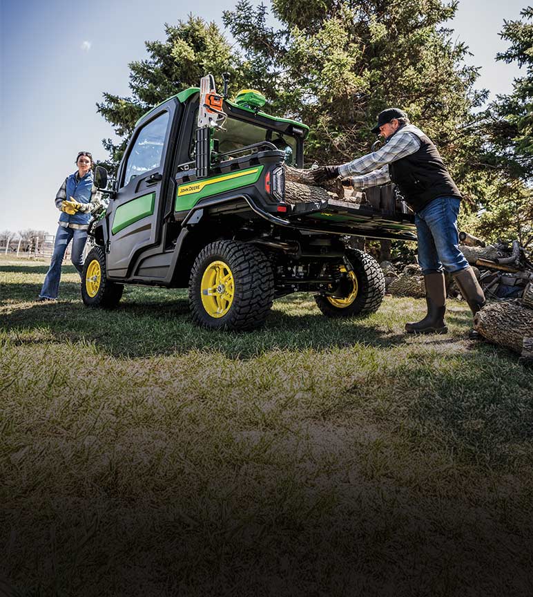 Man loading logs onto gator