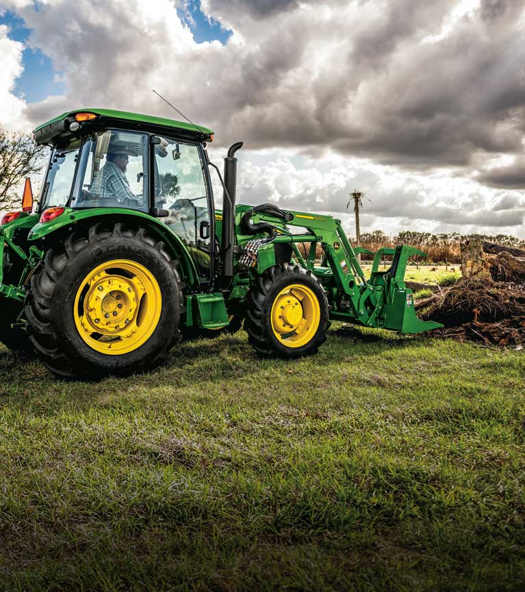 5 series tractor with loader digging up dirt