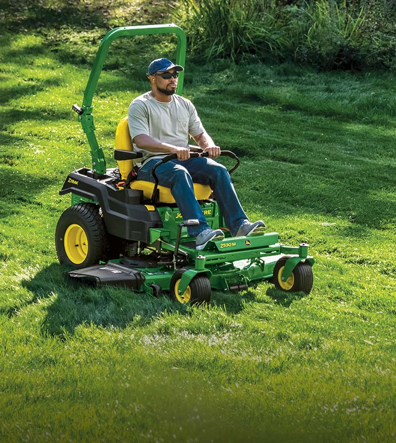 Man riding on Z530M ztrak mower mowing the lawn