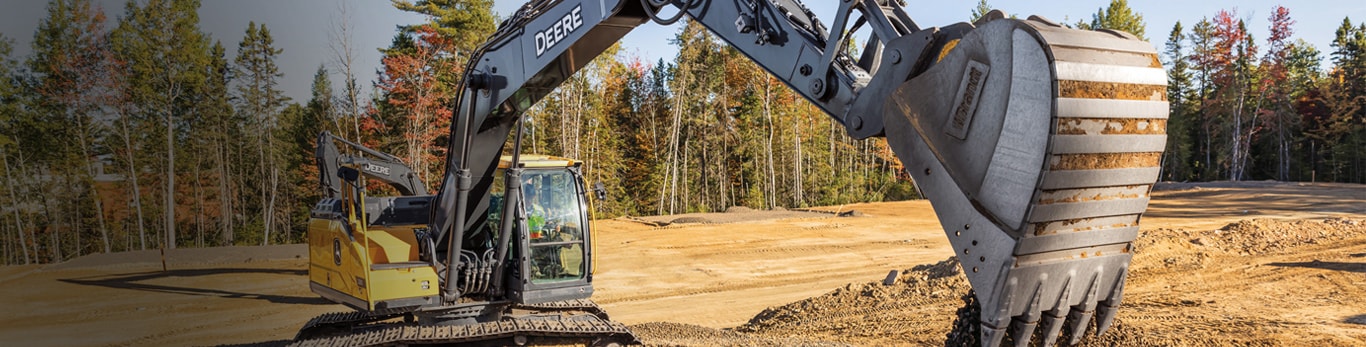 An excavator scoops a load of dirt on a construction jobsite