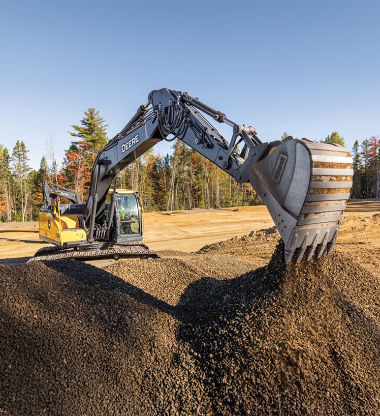 An excavator scoops a load of dirt on a construction jobsite