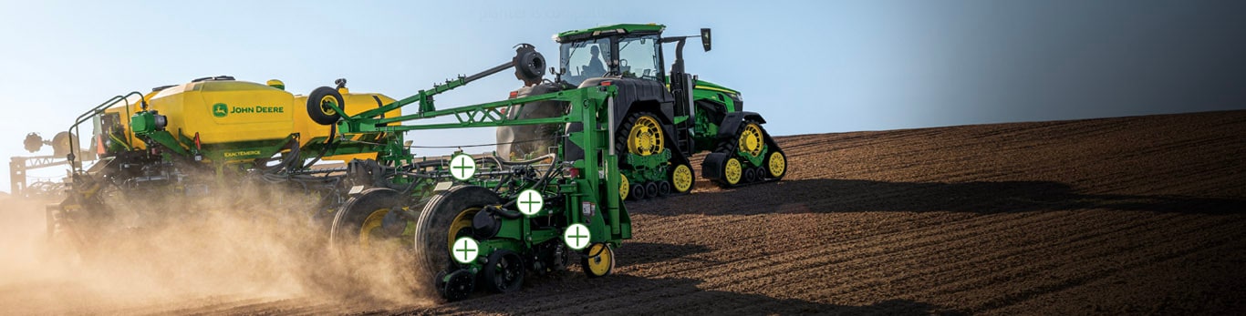 Tracteur de la série 9 remorquant un semoir de précision avec des icônes de zone sensible sur le semoir de précision