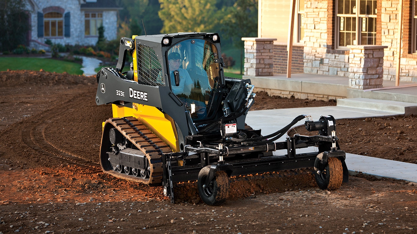 Compact Track Loader with power rake attachment.