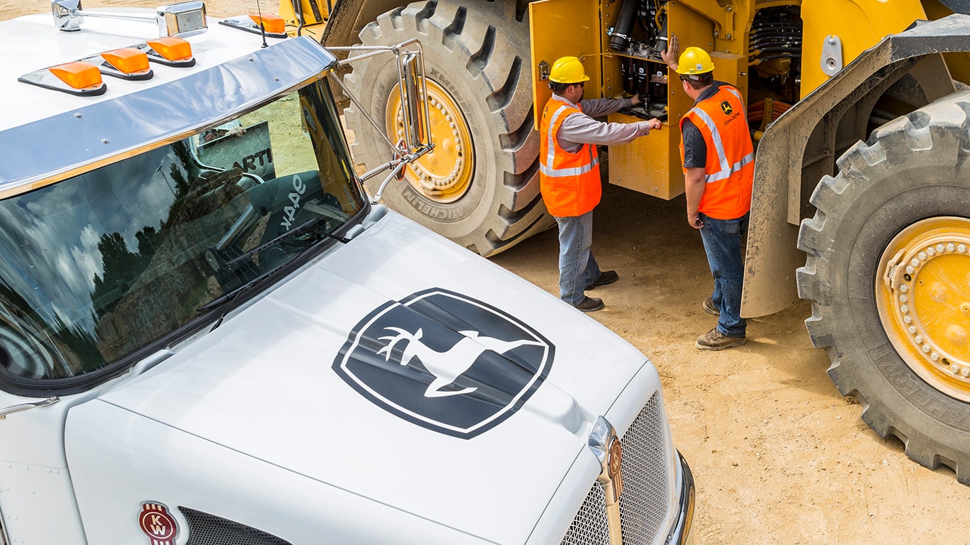 image of construction workers by equipment