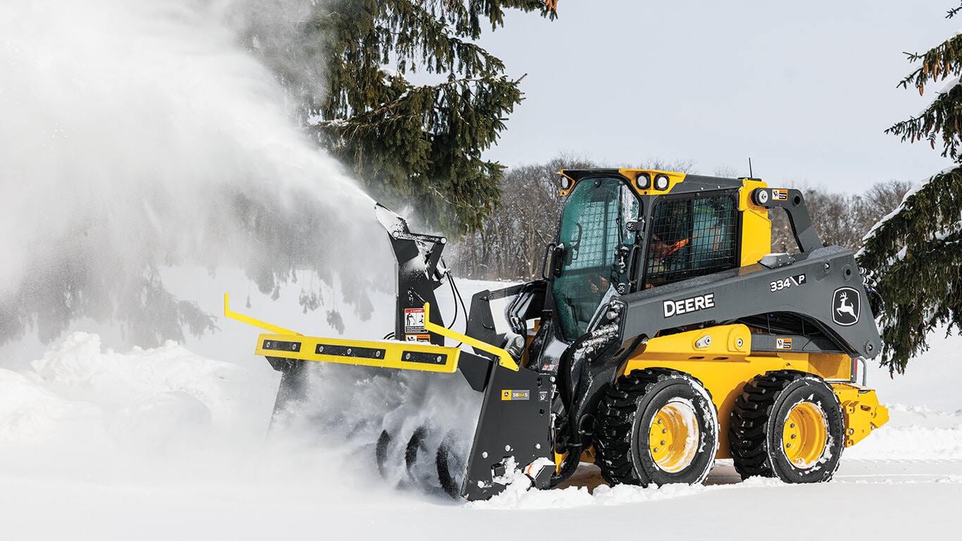334 P-Tier skid steer using snow blower attachment to clear snow.