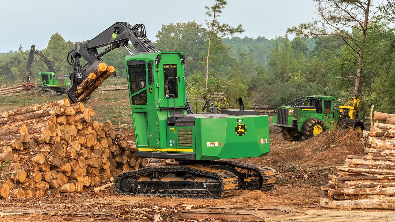 John Deere swing machine moving logs on landing