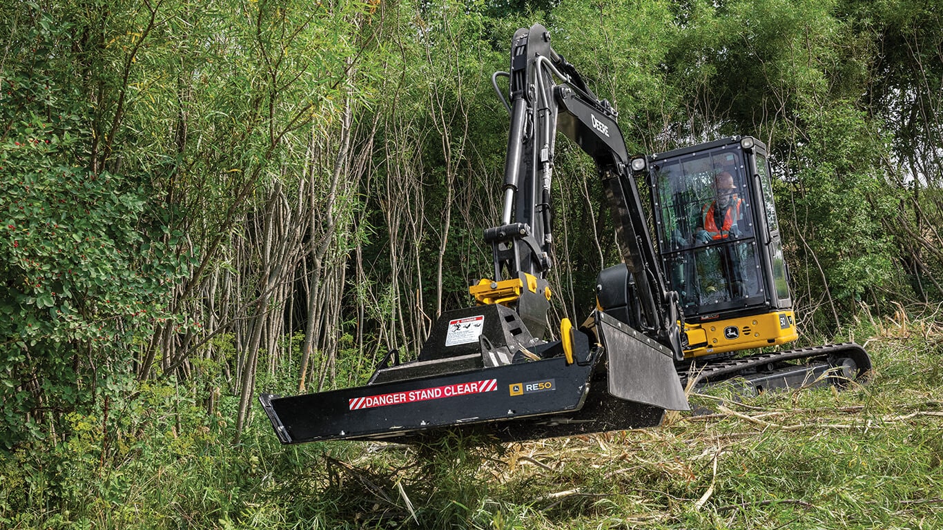 John Deere compact excavator using a John Deere RE50 brush cutter
