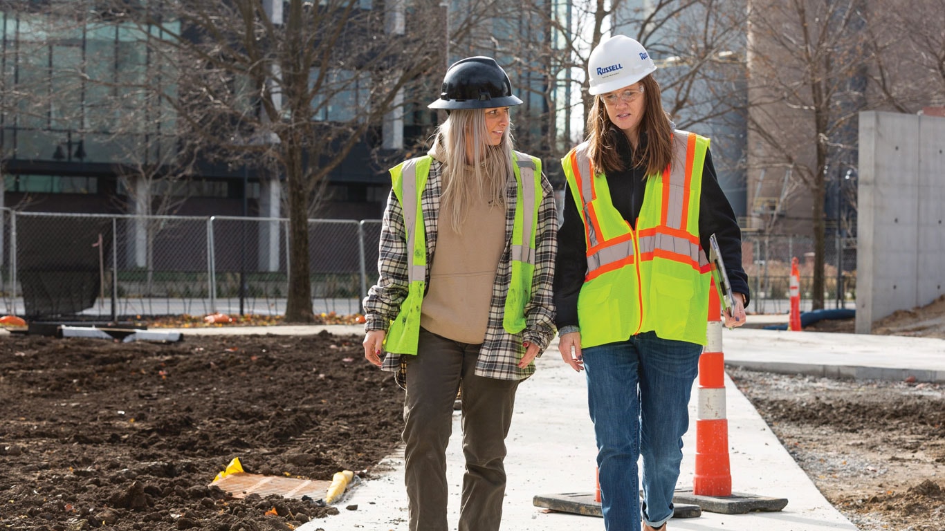 Russell women walk the job site.