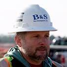 Mike Brown, owner of B&amp;S Site Development, wearing a hardhead in outdoor photo