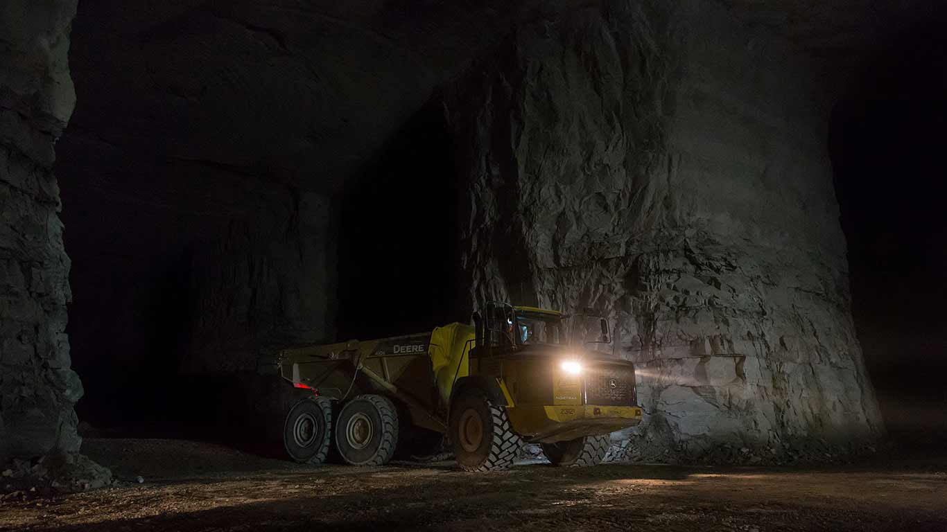 A dump truck drives through the underground mine