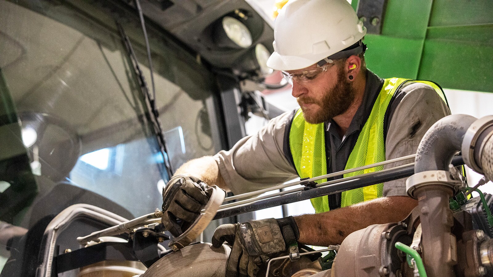 A technician works on a scraper tractor rebuild