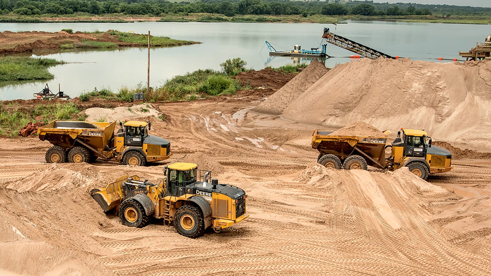 Fleet of John Deere machines working together on a construction site