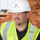 A head shot of Shaun Gonzales wearing a safety vest and white hard hat with WESCO printed on the front.