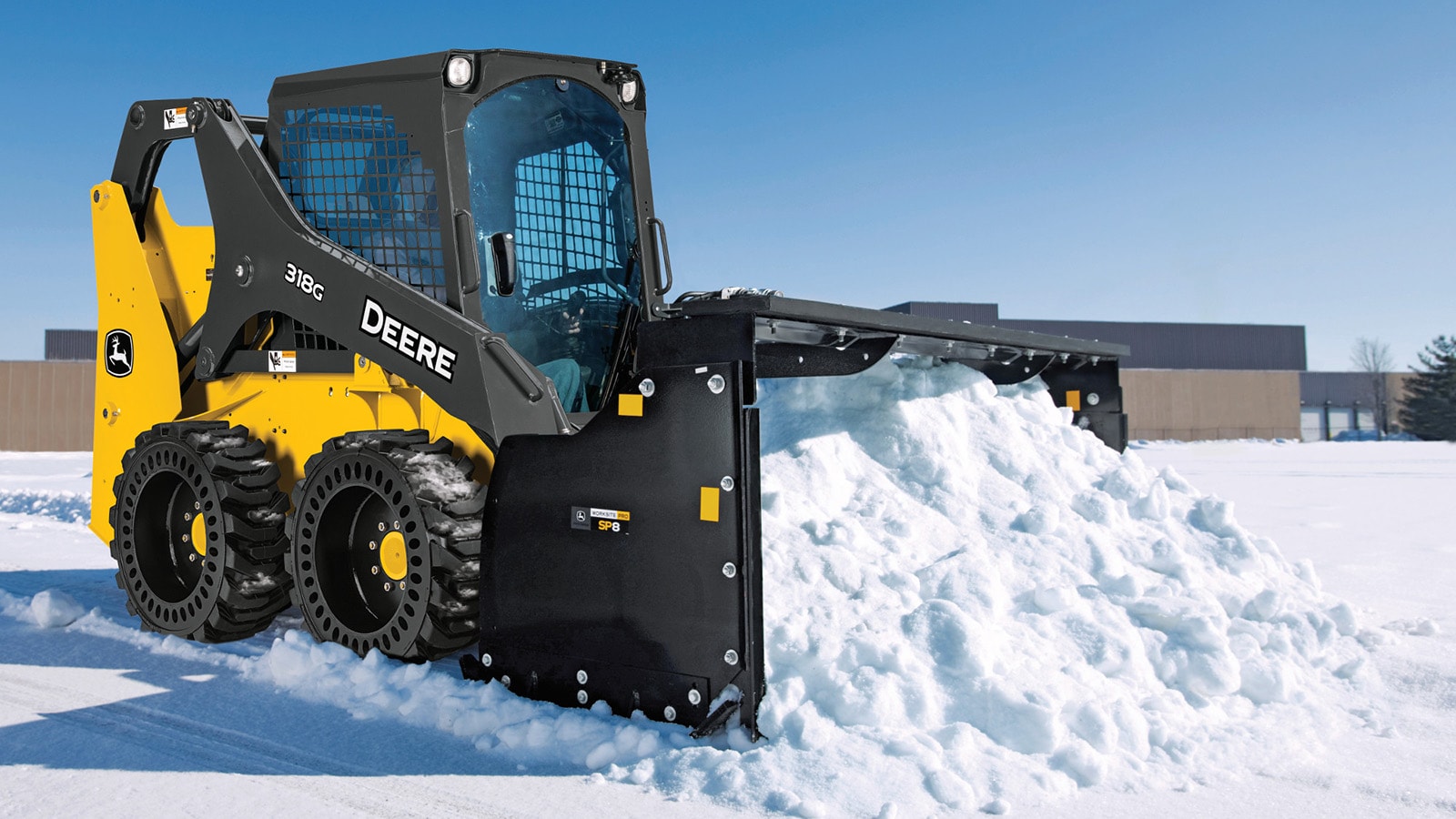 318G Skid Steer with snow pusher attachment removing snow