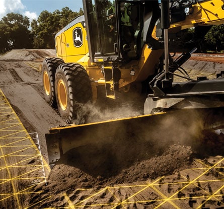 A John Deere MotorGrader leveling dirt with the assistance of SmartGrade.