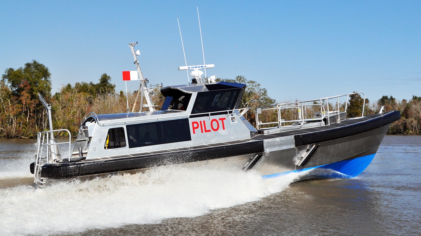 A Pilot boat generating a wake on the water.