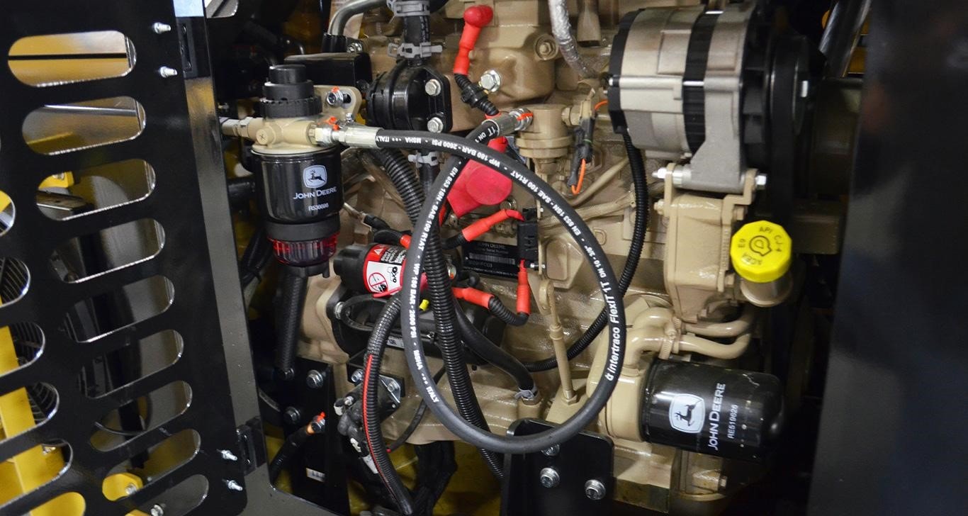 A John Deere Tier 4 Industrial Engine Inside a Wheel Loader With A Diamond Boom Mower Attachment