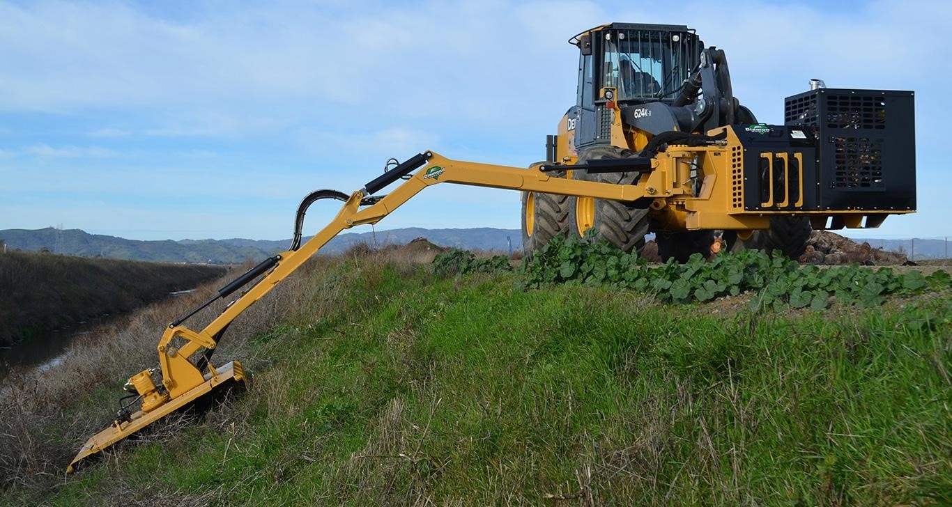 Diamond Mower Attached to a John Deere Wheel Loader on the Side of a Hill