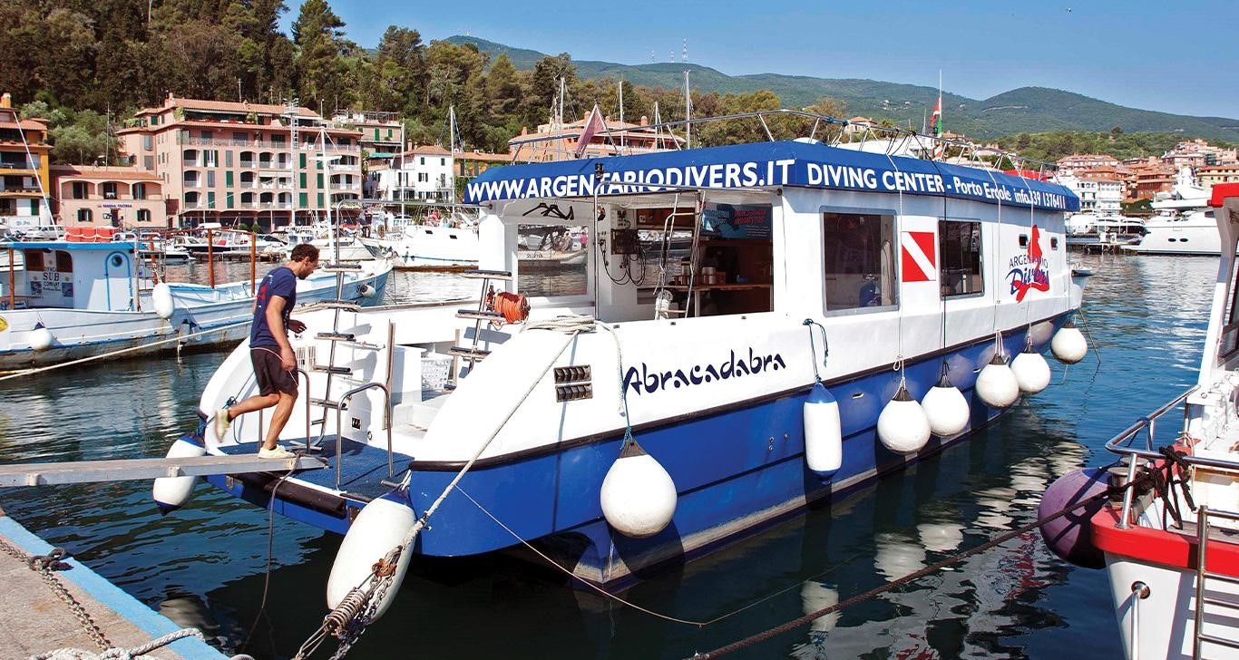 Abracadabra Dive Boat Powered by John Deere Marine Engine Docked in Tuscany Archipelago Harbor
