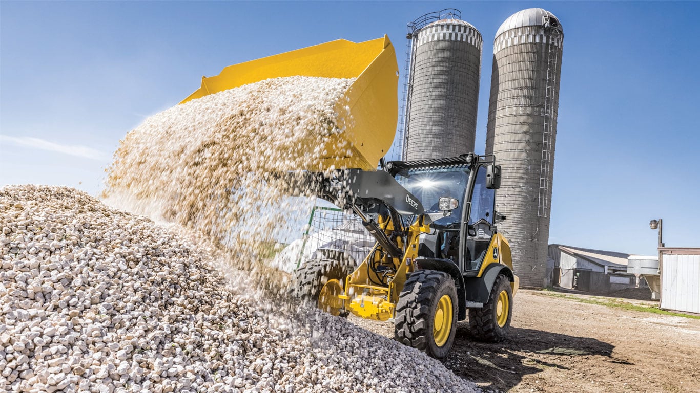 G-Tier Compact Wheel Loader dumping rocks on the job site