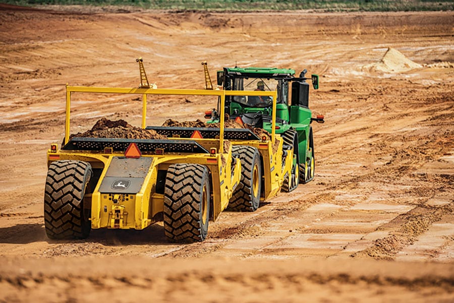 John Deere scraper in mud field