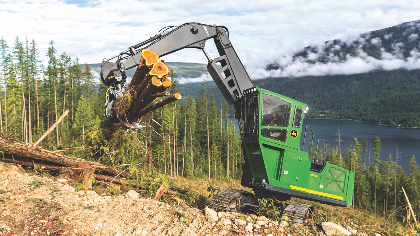 2956G crawler log loader picking up logs in the woods