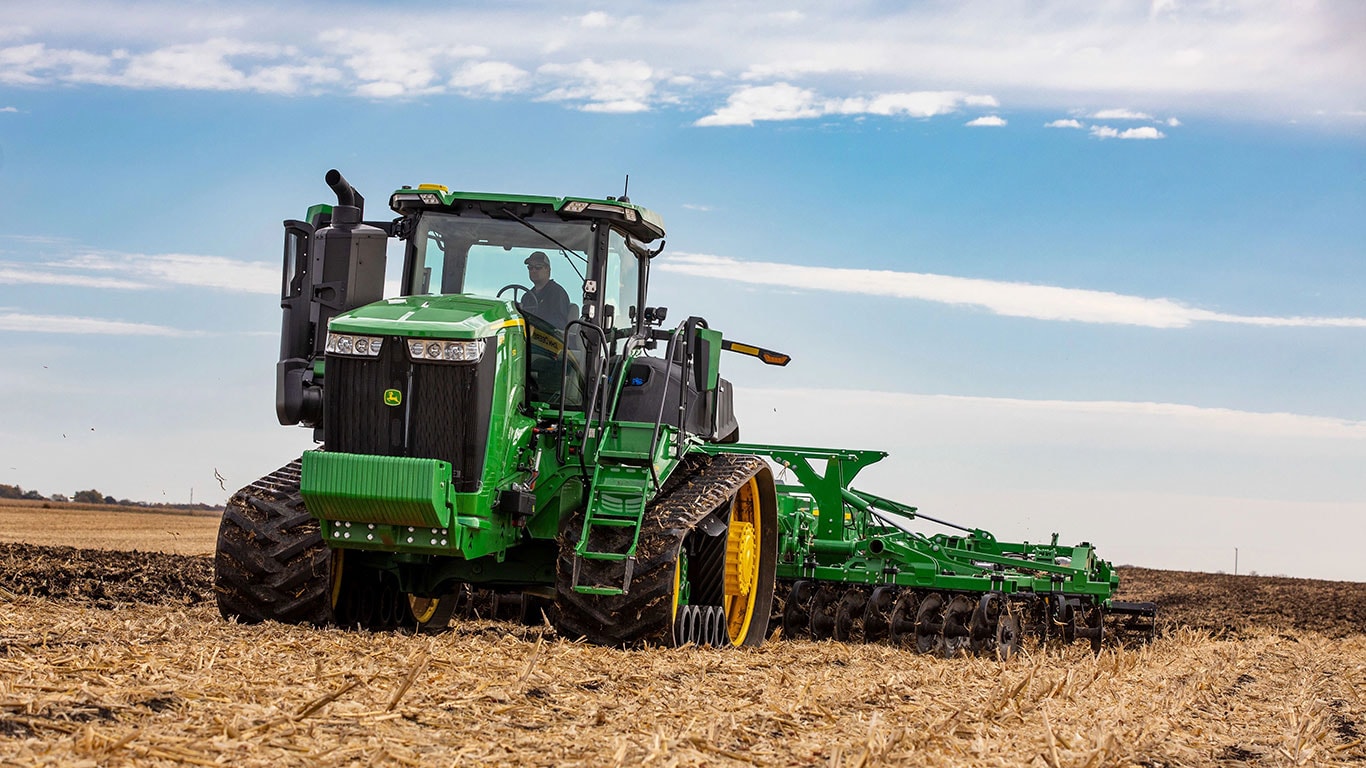 Track tractor working in field pulling a tillage implement.