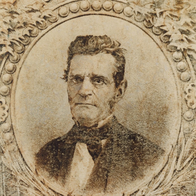 Historical image of John Deere in elaborate printed frame	