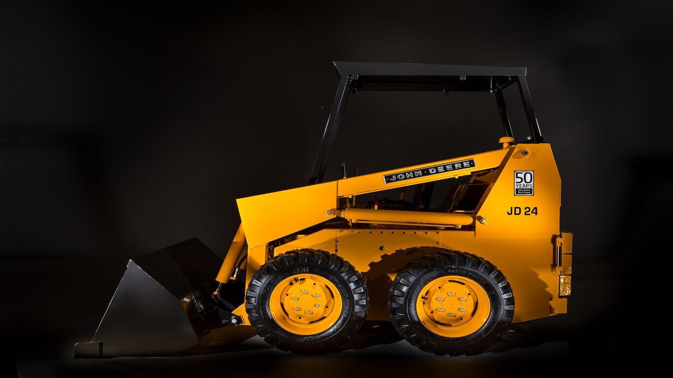 Side view studio image of the JD24 Skid Steer Loader with a 50th anniversary decal