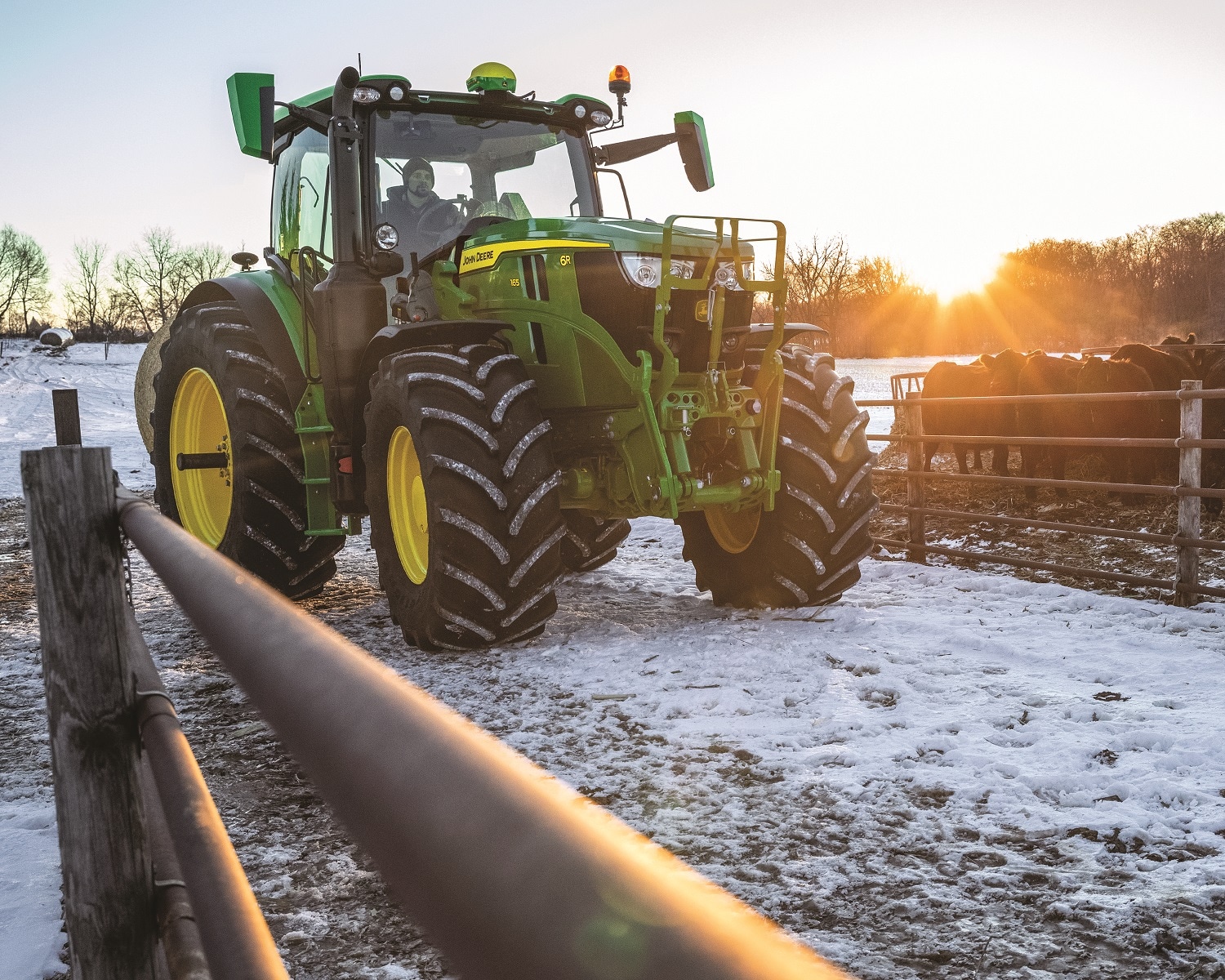 A 6R tractor on a snowy farm lot