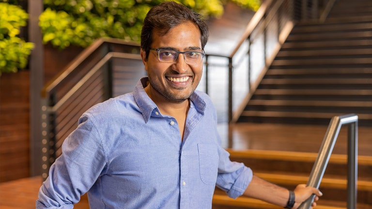 Gaurav Bansal stands in front of a staircase.