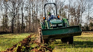 man tilling a field with a tractor