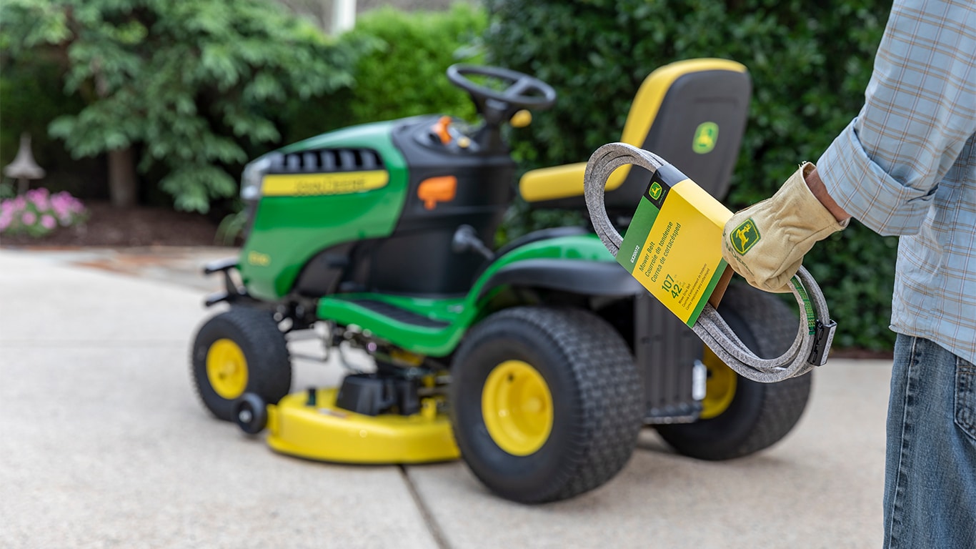 Man holding mower parts