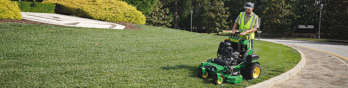 A man mowing with a QuikTrak mower