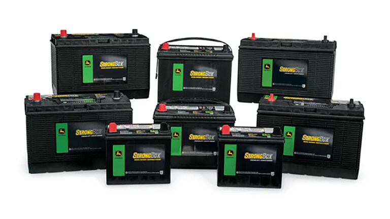 studio shot of various stacked Deere batteries