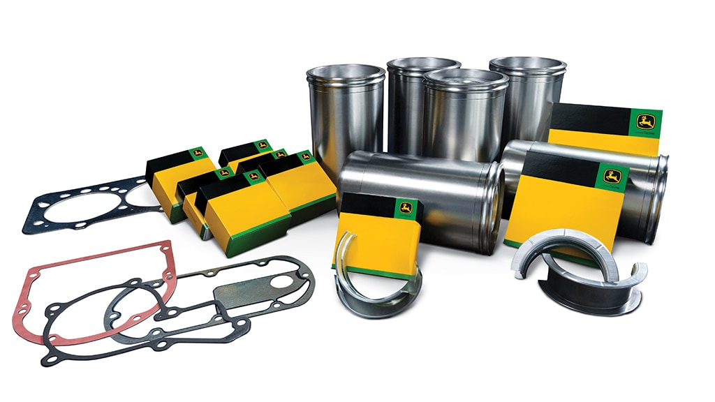 Kit de révision du moteur avec manchons métalliques, joints plats et boîtes de marque jaune-vert.