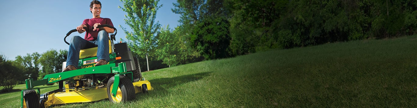 A man mowing on a Z445 John Deere