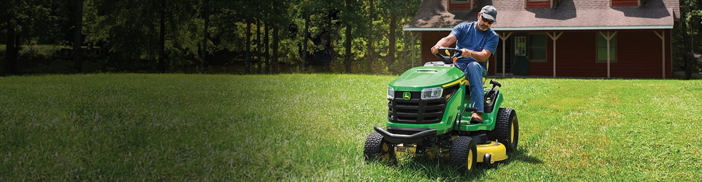 Man mowing his lawn on a riding mower