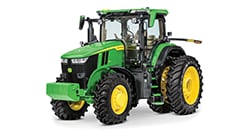 Green John Deere 7 Series tractor with enclosed cab and large agricultural tires displayed on a white background.