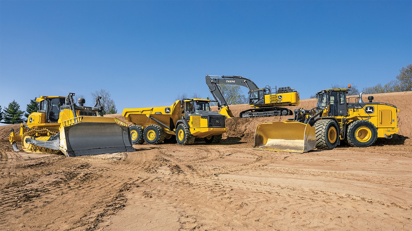 various Deere construction vehicles on dirt terrain
