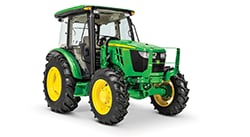 Green John Deere 5E/5M utility tractor with enclosed cab and agricultural tires displayed on a white background.