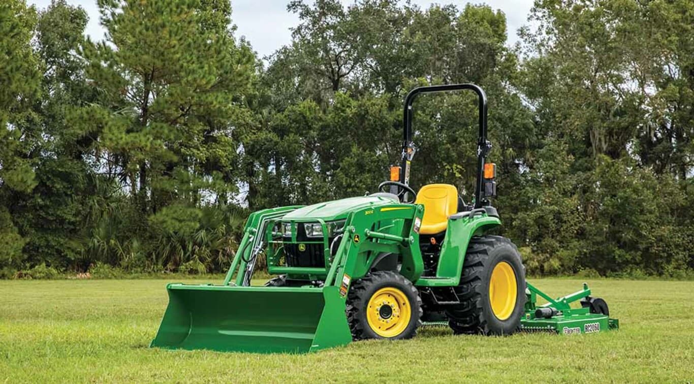 A 3025E Tractor standing in a green field.