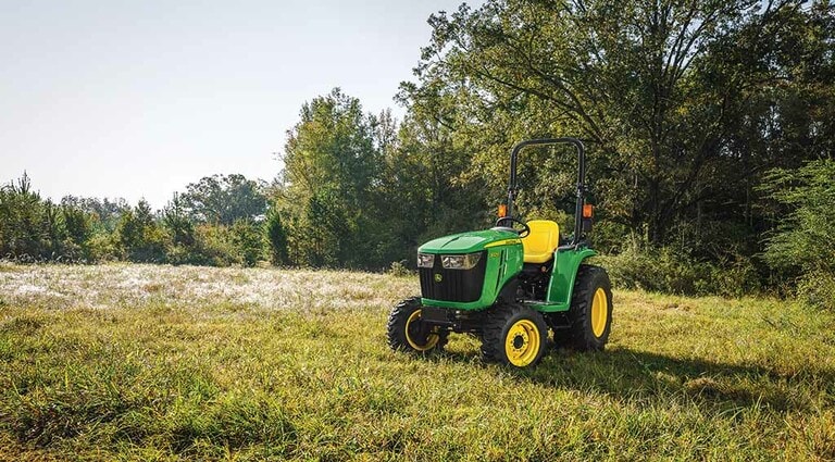 A 3025E Tractor positioned in a lush field.